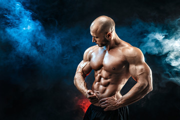 Strong bodybuilder man with perfect abs, shoulders,biceps, triceps, chest