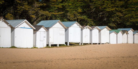 Fototapeta na wymiar old white beach huts