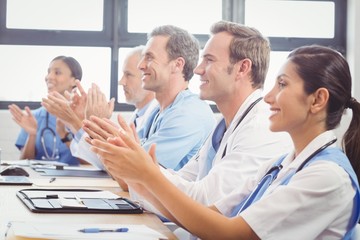 Medical team applauding in conference room