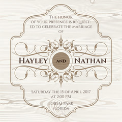 Wedding invitation. Decorative frame on wooden background.