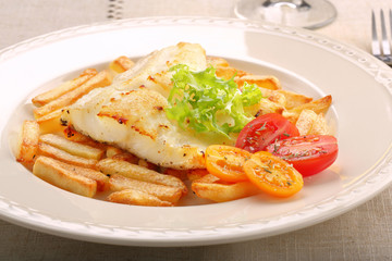 Baked fish and chips on elegant plate