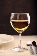 Glass of white wine on wooden background