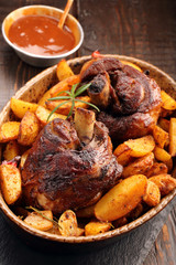 Knuckle of turkey with baked potato and dip