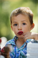 Funny kid eats red cake