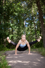 Blond young woman doing Firefly yoga posture