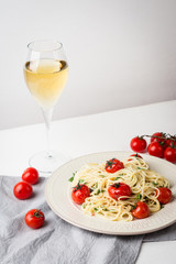 Pasta with cherry tomatoes on the wooden background