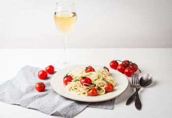 Pasta with cherry tomatoes on the wooden background