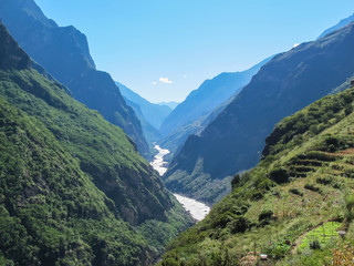 Waterfall and Mountain at Tiger Leaping Gorge. Located 60 kilometers north of Lijiang City, Yunnan Province, China.
