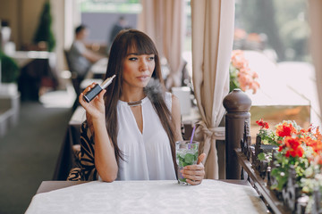 girn in cafe with E-Cigarette