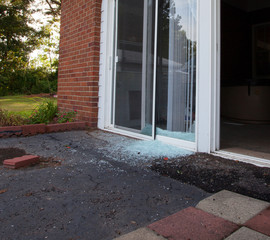 Crime's aftermath shows in the shattered glass after a home invader broke into the house