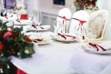 White table set for dinner with empty wineglasses