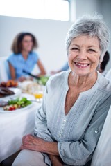 Portrait of senior woman sitting at dinning table