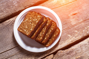 Sliced bread on a plate. Slices of brown grain bread. Recipe of homemade bread. Healthy savoury food.