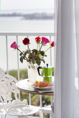 Breakfast with coffee on hotel's balcony, fresh croissants and s