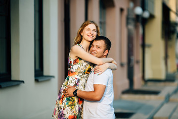 Fototapeta premium Cute couple lovely hugging in city at sunny day