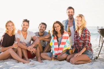 Friends drinking beer at the beach