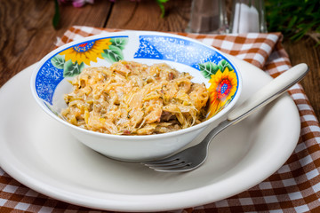 Fried cabbage greens and onion in wooden table.