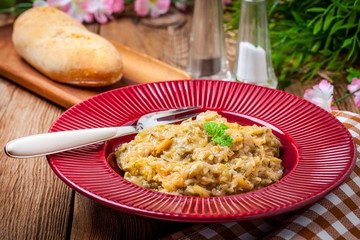 Fried cabbage greens and onion in wooden table.