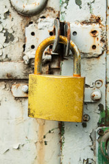 close-up old rusty golden padlock on door in construction trailer