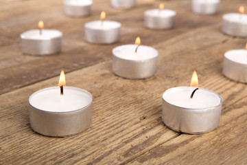 Fototapeta na wymiar Candles on wooden background