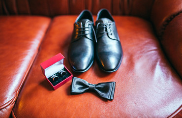 Set of groom clothes. Wedding rings, shoes, cufflinks and bow tie detalis