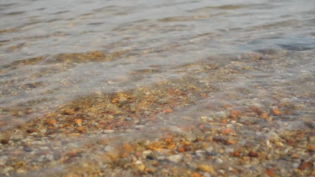 Lake with clear water and stones on the ground