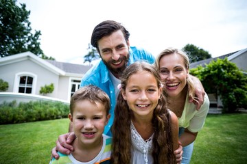 Obraz premium Portrait of family standing outside house in yard