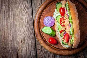 Homemade sandwich on a wooden table.