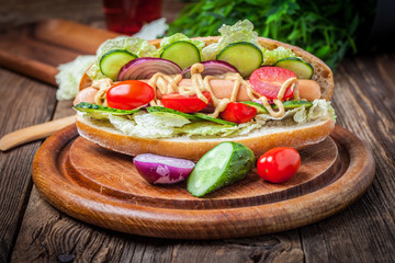 Homemade sandwich on a wooden table.