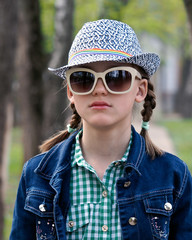 Portrait of a teenager girl glasses hat