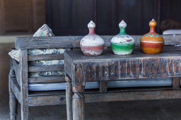 Fototapeta na wymiar Three decorative vases mexican style on wooden vintage table