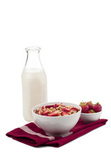 cereal rings with strawberry fruits and milk bottle