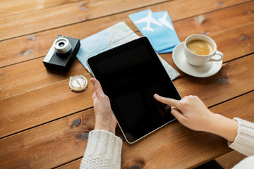 close up of traveler hands with tablet pc and map