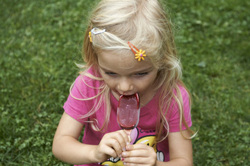 Beautiful little child blond girl eats - licking icecream in the summer © Petr Bonek