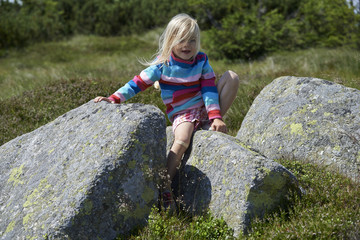 Naklejka na ściany i meble Posing young child blond girl in mountain region