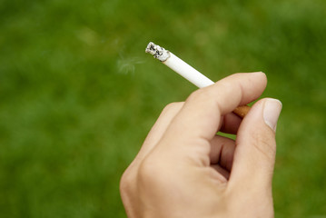 Close-up of cigarette is in the hand of man
