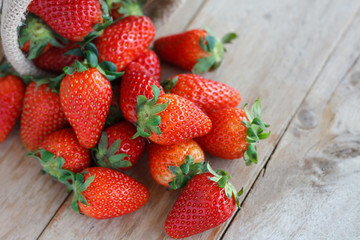 strawberries in small sack on wooden table background