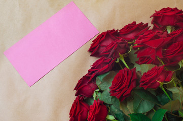 Empty lilac postal envelope and bouquet of roses