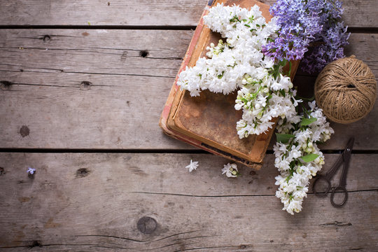 Background with fresh aromatic lilac flowers  on old books 