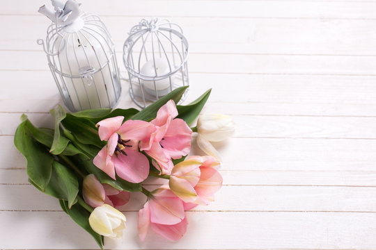 Fresh  spring white and pink  tulips and candles in decorative 