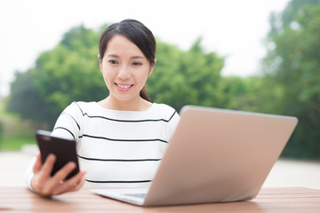 Fototapeta premium woman using laptop and smartphone