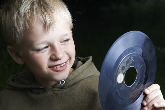 Young boy playing with the vinyl record