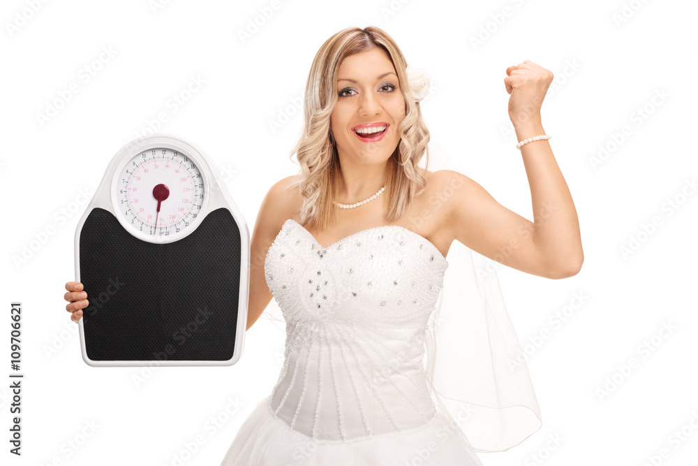 Wall mural joyful bride holding a weight scale