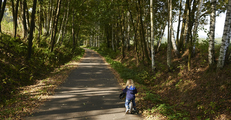 cute little girl riding runbike in summer

