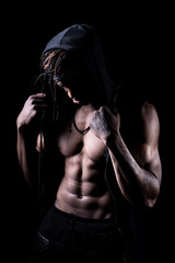 Obraz na płótnie Canvas Studio shot of muscular afroamerican man posing with black background