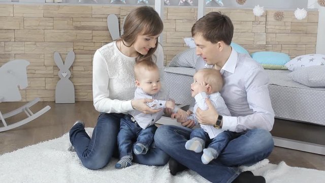 Parents with baby boy twins. people, family, happiness concept and idea.