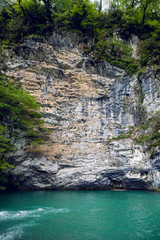 Fototapeta na wymiar small mountain lake with green surface at the rock 