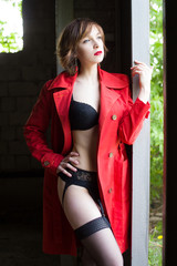 Attractive woman alluring in lingerie and coat.