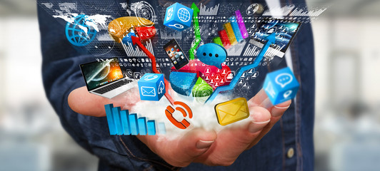 Businessman holding tech devices and charts in his hand