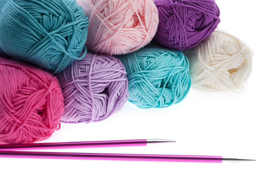Colorful wool yarn hanks with knitting needles